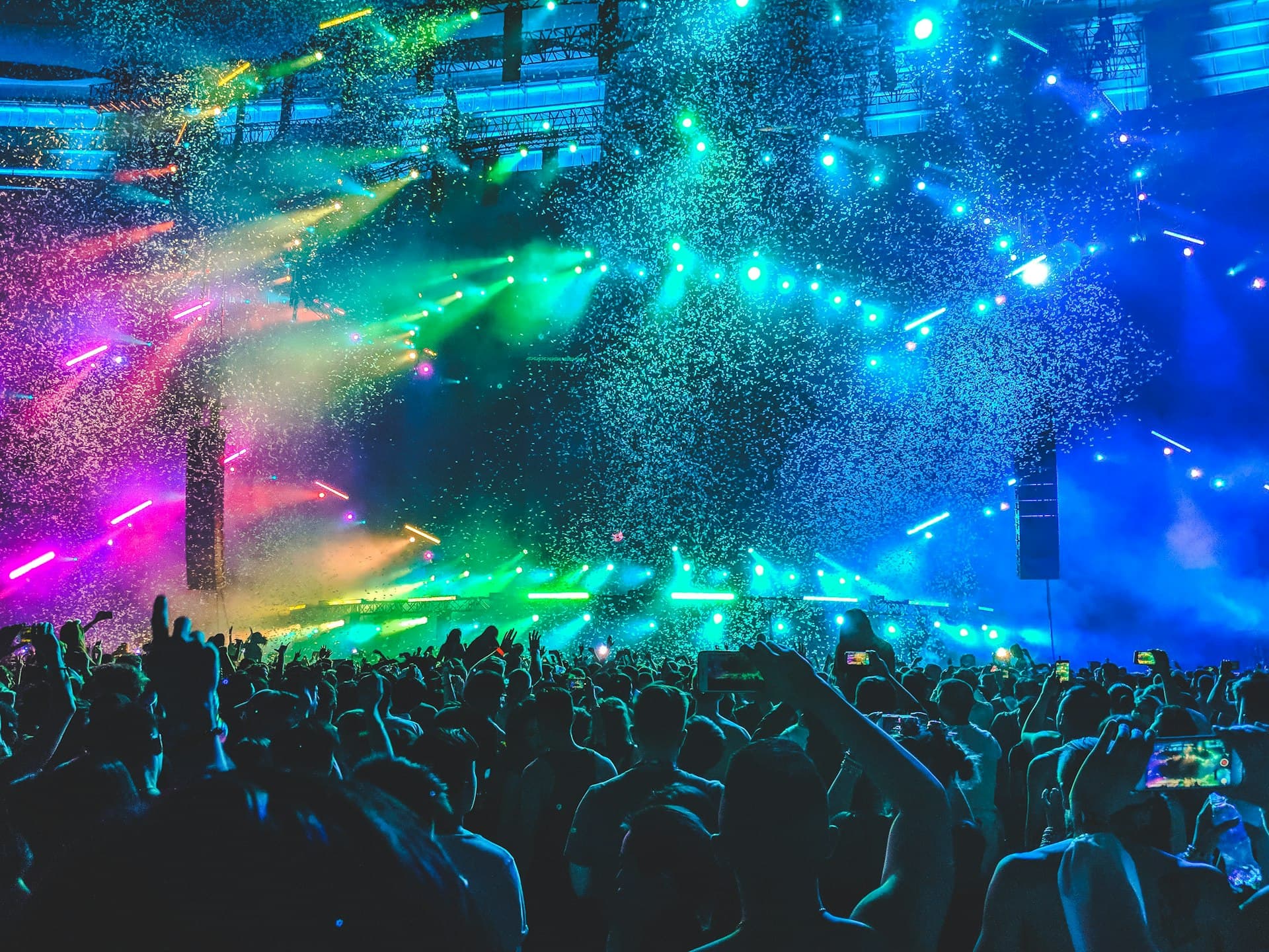 Festival crowd under rainbow stage lights